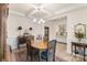 Formal dining room with a wooden table, stylish chairs, and elegant lighting at 141 Rhuidean Ct, Troutman, NC 28166