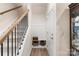 Bright entryway with staircase, coat rack, bench with storage, and wood flooring at 141 Rhuidean Ct, Troutman, NC 28166