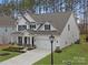 Beautiful two-story home with a manicured lawn, two-car garage, and inviting front porch at 141 Rhuidean Ct, Troutman, NC 28166