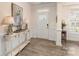 Welcoming foyer with decorative wainscoting, hardwood flooring, and ample natural light at 141 Rhuidean Ct, Troutman, NC 28166