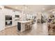 Bright, open kitchen with white cabinets, a central island, and stainless steel appliances at 141 Rhuidean Ct, Troutman, NC 28166