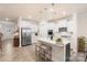 Bright, open kitchen with stainless steel appliances, quartz countertops, and a large center island at 141 Rhuidean Ct, Troutman, NC 28166