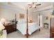 Main bedroom with a four-poster bed, ceiling fan, and ensuite bathroom access at 141 Rhuidean Ct, Troutman, NC 28166