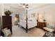Luxurious main bedroom with a tray ceiling, plush carpet, and lots of natural light at 141 Rhuidean Ct, Troutman, NC 28166