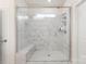 Sleek bathroom with a spacious walk-in shower featuring marble tiling and a built-in bench at 141 Rhuidean Ct, Troutman, NC 28166