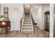 Well-lit staircase with carpeted steps and wooden railings leading to the upper level at 141 Rhuidean Ct, Troutman, NC 28166