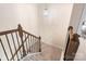 Carpeted staircase with decorative wood and iron banister and overhead lighting at 141 Rhuidean Ct, Troutman, NC 28166