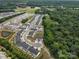 Aerial view of a new residential community with tree-lined streets, sidewalks, and green spaces at 164 Briana Marie Way, Indian Trail, NC 28079