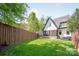 Well-kept backyard showcasing a manicured lawn, privacy fence, and screened in porch at 1711 Brook Rd, Charlotte, NC 28205