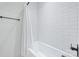 Clean white tiled bathtub and shower combo featuring modern fixtures at 1711 Brook Rd, Charlotte, NC 28205