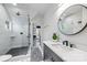 Modern bathroom featuring a glass-enclosed shower, white tile, and sleek fixtures at 1711 Brook Rd, Charlotte, NC 28205