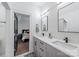 Bathroom with modern vanity, dual sinks, and stylish mirrors adjacent to bedroom view at 1711 Brook Rd, Charlotte, NC 28205
