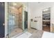 Bathroom featuring a glass walk-in shower, storage closet and elegant gold fixtures at 1711 Brook Rd, Charlotte, NC 28205