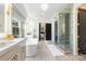 Well-lit bathroom featuring a large soaking tub, walk-in shower, and dual vanity sinks at 1711 Brook Rd, Charlotte, NC 28205