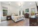 Bright bedroom showcasing a large bed, hardwood floors, recessed lighting and abundant natural light at 1711 Brook Rd, Charlotte, NC 28205
