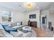 Bonus room featuring plush sofa, natural light, stylish lighting, and hardwood flooring at 1711 Brook Rd, Charlotte, NC 28205