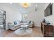 Bonus room features plush sectional sofa, stylish lighting, and hardwood flooring at 1711 Brook Rd, Charlotte, NC 28205