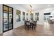Dining room with hardwood floors, a modern chandelier, table set for 6 and views to outdoor living at 1711 Brook Rd, Charlotte, NC 28205