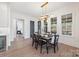 Bright dining room with hardwood floors, a modern chandelier, and large windows offering outdoor views at 1711 Brook Rd, Charlotte, NC 28205