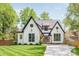 Beautiful two-story home with a manicured lawn, contrasting trim, and a modern glass front door at 1711 Brook Rd, Charlotte, NC 28205