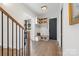 Charming foyer with hardwood floors, built-in bench, coat rack, and black door at 1711 Brook Rd, Charlotte, NC 28205