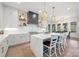 Contemporary kitchen with a marble waterfall island, seating, a range hood, and custom cabinetry at 1711 Brook Rd, Charlotte, NC 28205