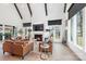 Bright living room with high ceilings, wood beams, and comfortable leather furniture at 1711 Brook Rd, Charlotte, NC 28205