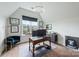 Bright office with a desk, large window, hardwood floors, and a blue chair at 1711 Brook Rd, Charlotte, NC 28205