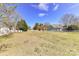 Backyard includes long, white fence, large grassy area and trees surrounding the property at 178 Harper Lee St, Davidson, NC 28036