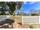 Home's backyard includes a long, white fence, grassy area and trees surrounding at 178 Harper Lee St, Davidson, NC 28036