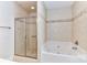 Bathroom featuring a glass-enclosed shower and a soaking tub at 178 Harper Lee St, Davidson, NC 28036