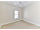 Neutral bedroom with beige carpet, white trim, ceiling fan and window with blinds at 178 Harper Lee St, Davidson, NC 28036