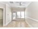 Versatile bonus room with ceiling fan, tile flooring, and natural light, offering flexibility for various uses at 178 Harper Lee St, Davidson, NC 28036
