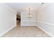 Spacious dining room with elegant chandelier and tile flooring, perfect for Gathering gatherings at 178 Harper Lee St, Davidson, NC 28036