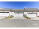 Attached townhome garages with white doors in a row under a clear blue sky at 178 Harper Lee St, Davidson, NC 28036