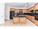 Well-equipped kitchen featuring custom cabinets, black appliances, and granite countertops, perfect for culinary enthusiasts at 178 Harper Lee St, Davidson, NC 28036
