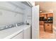 Convenient laundry room featuring washer, dryer, and ample shelving space at 178 Harper Lee St, Davidson, NC 28036