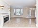 Cozy living room features tile flooring, a fireplace, and large windows, creating a warm and inviting space at 178 Harper Lee St, Davidson, NC 28036