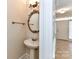 Charming powder room with decorative mirror and pedestal sink at 178 Harper Lee St, Davidson, NC 28036
