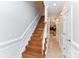 Classic stairway with wooden steps, white risers, and views to the kitchen at 178 Harper Lee St, Davidson, NC 28036