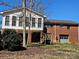 Exterior view of the backyard featuring a two-story home with brick and siding at 1873 Rocky River Rd, Lancaster, SC 29720