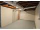 Basement with exposed ducts, painted walls and floor, and wooden door at 1873 Rocky River Rd, Lancaster, SC 29720