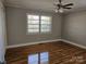 Bright bedroom with hardwood floors, a ceiling fan, and a window offering natural light at 1873 Rocky River Rd, Lancaster, SC 29720
