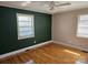 Cozy bedroom with dual windows, ceiling fan, and beautiful hardwood flooring at 1873 Rocky River Rd, Lancaster, SC 29720