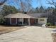 Charming single-story brick home with a covered front porch and well-maintained landscaping at 1873 Rocky River Rd, Lancaster, SC 29720