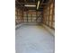 Interior of metal shed with concrete floor and wooden framing, illuminated by overhead lighting at 1873 Rocky River Rd, Lancaster, SC 29720