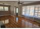 Bright living room with hardwood floors, large windows, and a ceiling fan at 1873 Rocky River Rd, Lancaster, SC 29720