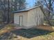 Exterior view of metal shed with metal roof and concrete foundation, surrounded by a wooded area at 1873 Rocky River Rd, Lancaster, SC 29720