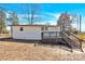 Back exterior featuring a wooden deck, access stairs and white siding at 188 Bailey Rd, Mooresville, NC 28117