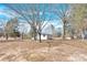 View of a single story home with bare trees in a large yard with blue skies and few clouds at 188 Bailey Rd, Mooresville, NC 28117